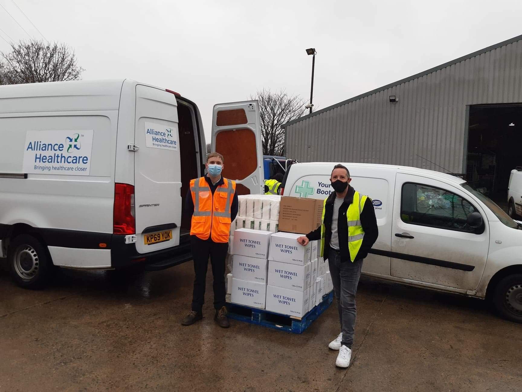 Alliance Healthcare employees with donations next to van